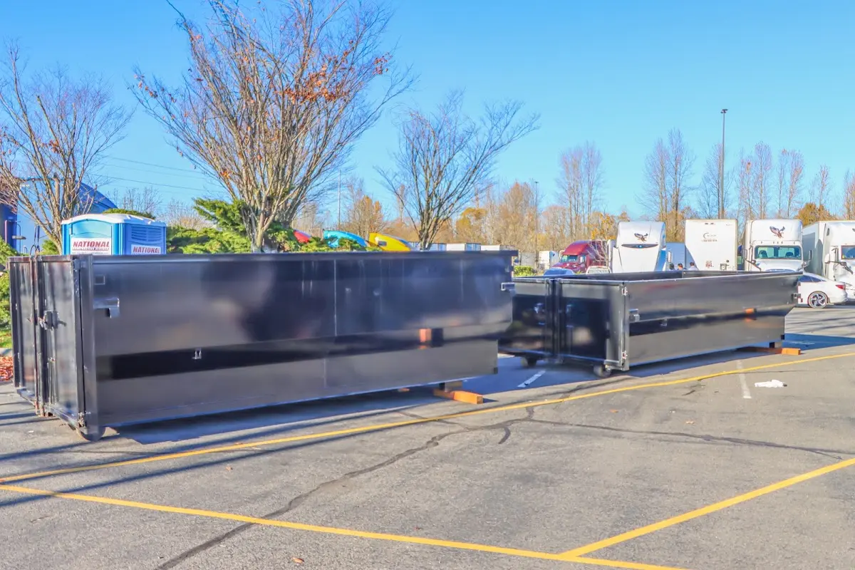 Professional dumpster rental service with roll-off container on residential driveway in Cranford